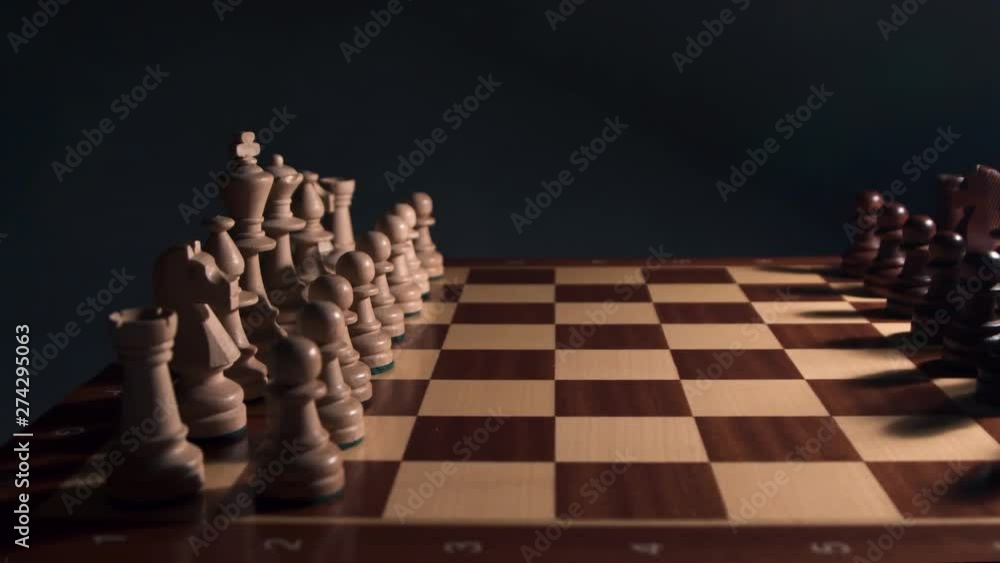 Chess Closeup in dramatic light Wooden Chess Board, Business Concept, Dark Background. Slide Camera. Chess Closeup in dramatic light Wooden Chess Board, Business Concept, Dark Background. Slide Camera.
