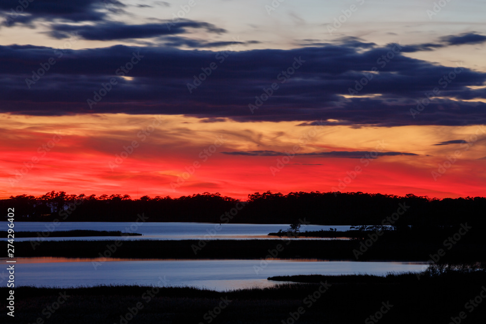 A scarlet sunset over Buzzard Bay in Roanoke Sound as seen from Run