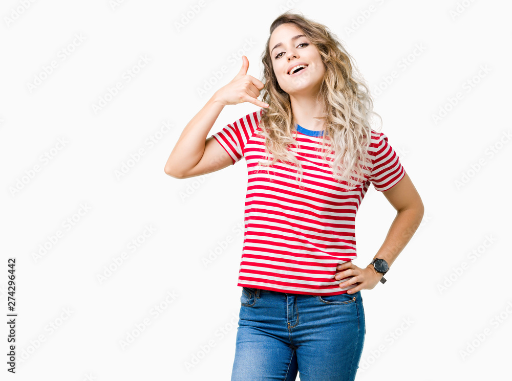 Beautiful young blonde woman over isolated background smiling doing phone gesture with hand and fingers like talking on the telephone. Communicating concepts. Beautiful young blonde woman over isolated background smiling doing phone gesture with hand and fingers like talking on the telephone. Communicating concepts.