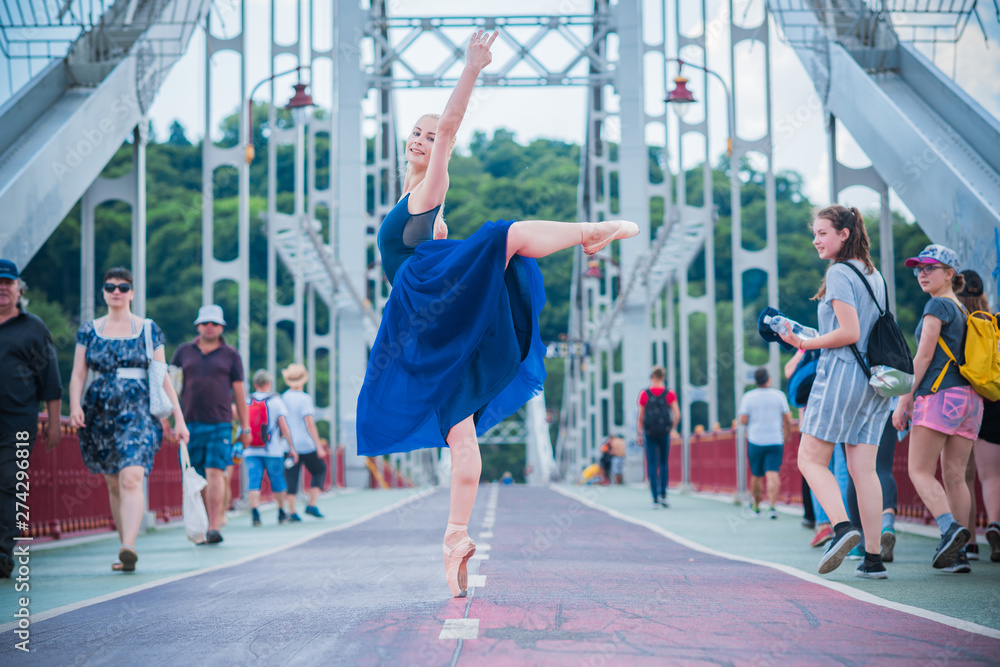 Young ballerina in ballet costume dancing in city , feeling breath of ...