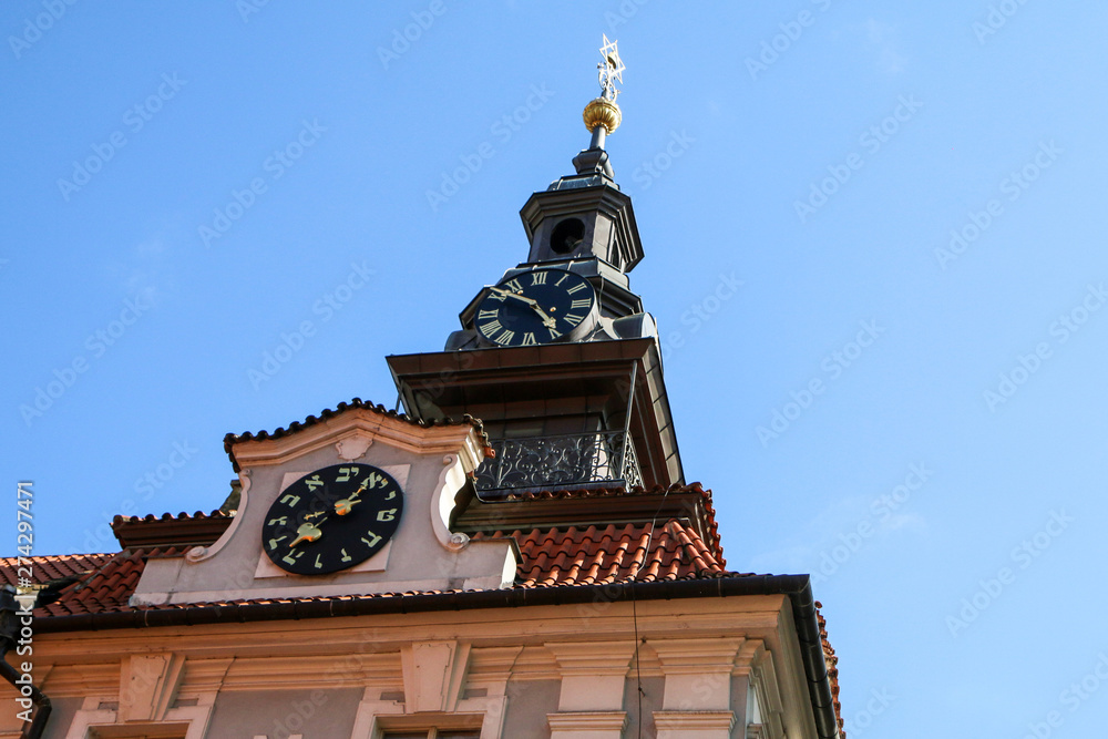 The comparisson of two clocks. The regular with arabic numbers and the jewis one. They are on one tower of the church. The comparisson of two clocks. The regular with arabic numbers and the jewis one. They are on one tower of the church.