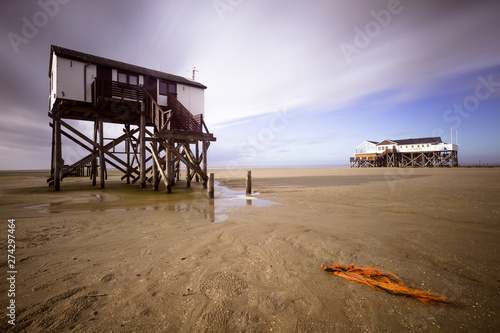 Pile dwellings on the beach of the German Sea in St. Peter Ording, Germany. photo