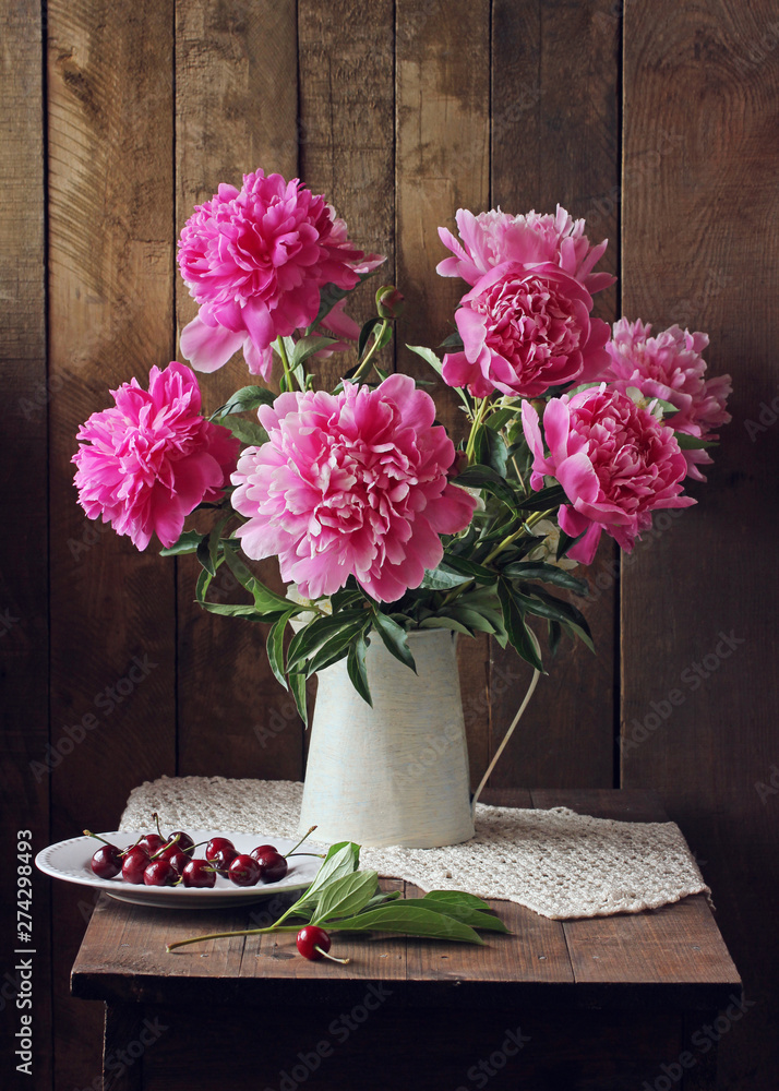 pink peonies and cherries. rural still life. pink peonies and cherries. rural still life.