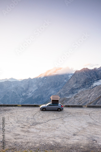 Stelvio Pass,  Ortler Alps, South Tyrol / Sondrio, Italy: A car with a rooftop tent parked in the mountains just below the peak of the highest paved mountain pass in the Eastern Alps. photo