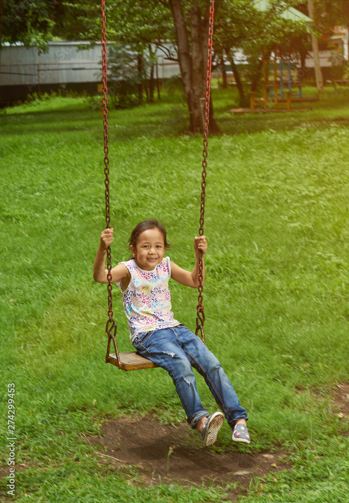 Asian girl on a swing