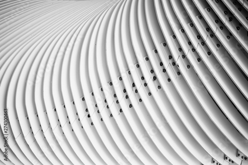 Abstract details of curved metal stairs. Black and white photography.