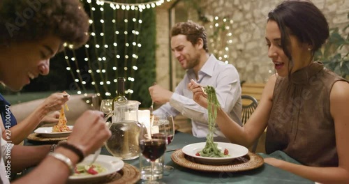 Four people, two couples happy talking and eating during a romantic gourmet dinner or lunch.Wide shot. Friends italian trip in Umbria.4k slow motion