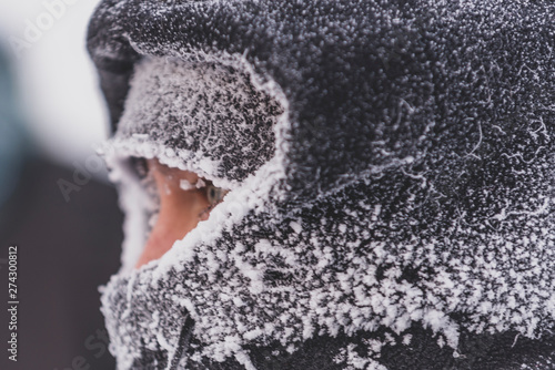 Close up of man with frozen clothes in very cold weather