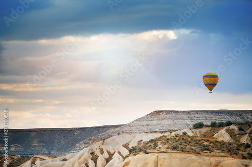 Hot air balloon flying over the rocks photo