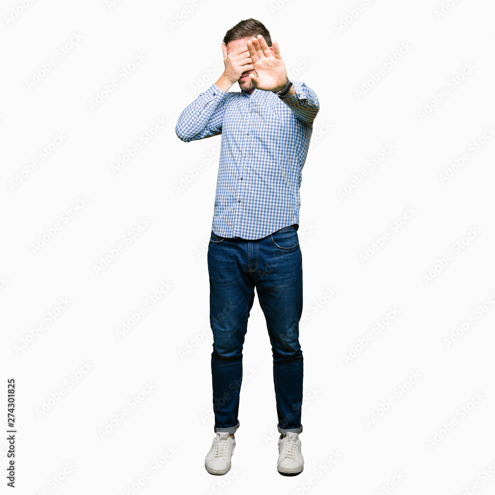 Handsome business man with blue eyes covering eyes with hands and doing stop gesture with sad and fear expression. Embarrassed and negative concept. Handsome business man with blue eyes covering eyes with hands and doing stop gesture with sad and fear expression. Embarrassed and negative concept.