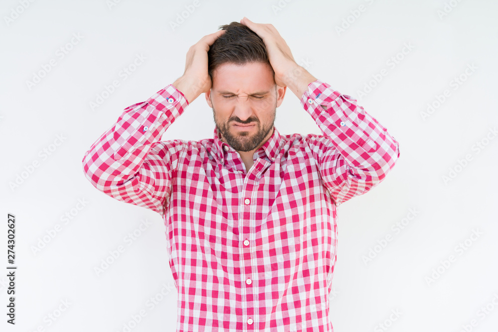 Young handsome man wearing shirt over isolated background suffering from headache desperate and stressed because pain and migraine. Hands on head. Young handsome man wearing shirt over isolated background suffering from headache desperate and stressed because pain and migraine. Hands on head.