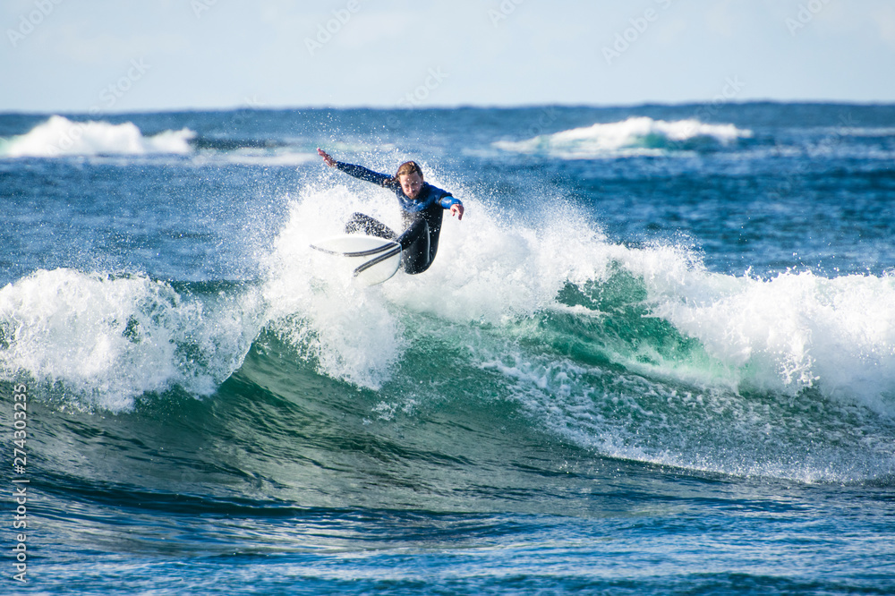 Surfer exploring the coast of Ireland on a surf trip Surfer exploring the coast of Ireland on a surf trip