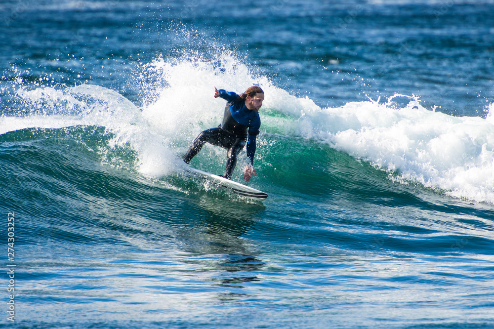 Surfer exploring the coast of Ireland on a surf trip Surfer exploring the coast of Ireland on a surf trip