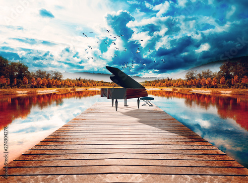 Piano en la naturaleza.Paisaje surreal de arboles y lago.Concepto de música relajada y tranquila de piano photo