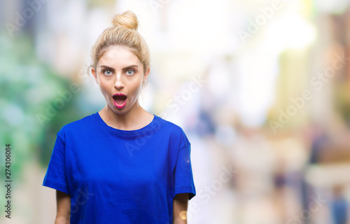 Young beautiful blonde and blue eyes woman wearing blue t-shirt over isolated background afraid and shocked with surprise expression, fear and excited face.