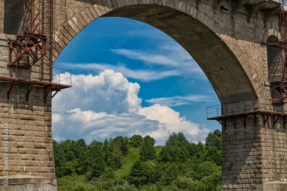 Beautiful old arched stone railway bridge close-up