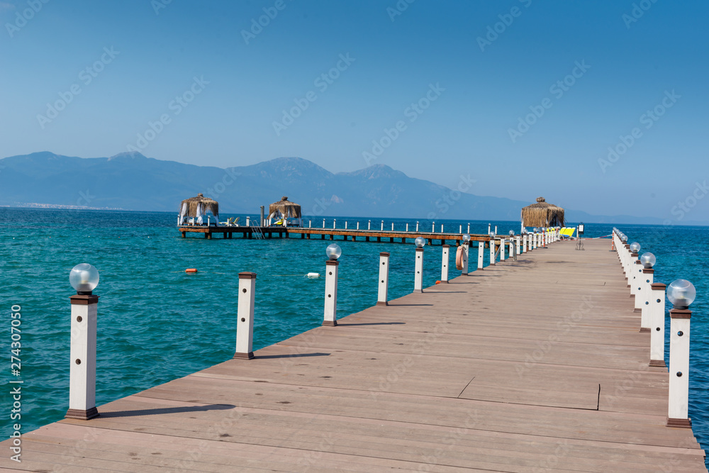 Wood arbor is in a sunny beach. Blue sky and mountain in the background. Vacation and holiday on beach concept. Wood arbor is in a sunny beach. Blue sky and mountain in the background. Vacation and holiday on beach concept.