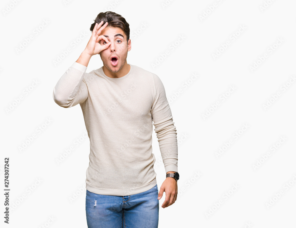 Young handsome man over isolated background doing ok gesture shocked with surprised face, eye looking through fingers. Unbelieving expression. Young handsome man over isolated background doing ok gesture shocked with surprised face, eye looking through fingers. Unbelieving expression.