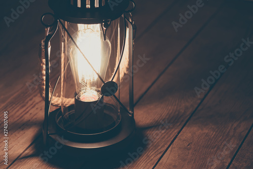 retro lamp on wooden floor, ghost tour, creepy light from lantern