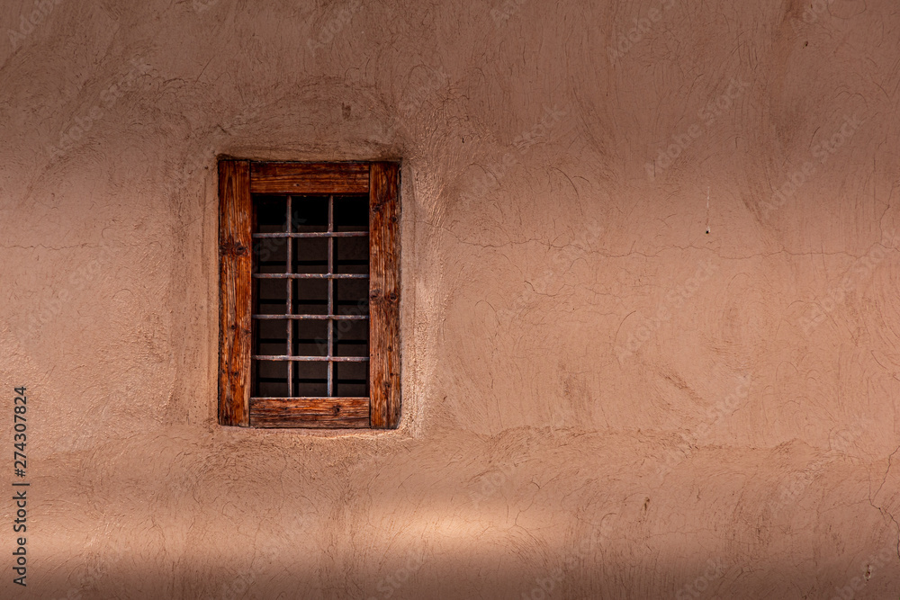 Close up view of a small traditional window on the wall made of mud. Marrakesh, Morocco.