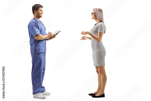 Young woman talking to a male doctor in a blue uniform