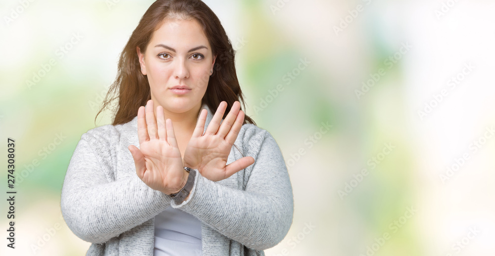 Beautiful plus size young woman wearing winter jacket over isolated background Rejection expression crossing arms and palms doing negative sign, angry face Beautiful plus size young woman wearing winter jacket over isolated background Rejection expression crossing arms and palms doing negative sign, angry face