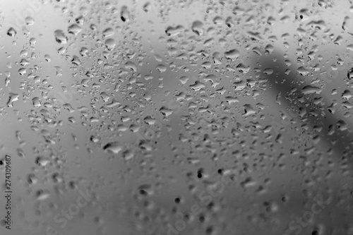 rain water drops on glass window blurred background selective focus close up