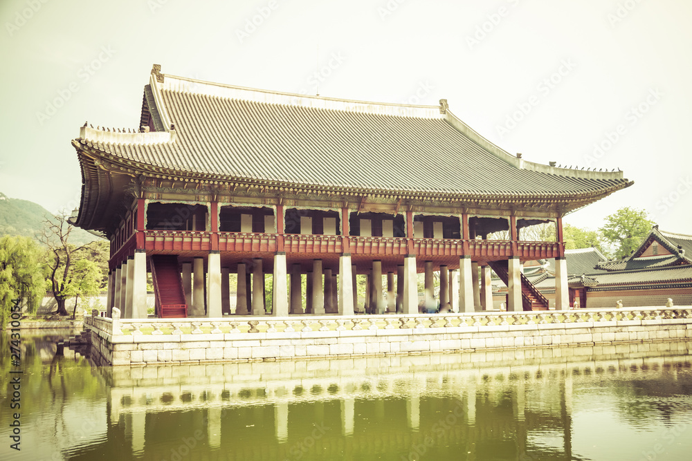 A building on the grounds of Gyeongbokgung Palace in Seoul, South Korea with a pond. This image is developed to give the impression that it is very old. A building on the grounds of Gyeongbokgung Palace in Seoul, South Korea with a pond. This image is developed to give the impression that it is very old.