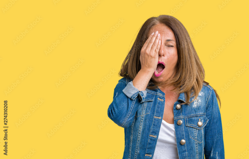 Beautiful middle age woman wearing casual denim jacket over isolated background Yawning tired covering half face, eye and mouth with hand. Face hurts in pain. Beautiful middle age woman wearing casual denim jacket over isolated background Yawning tired covering half face, eye and mouth with hand. Face hurts in pain.