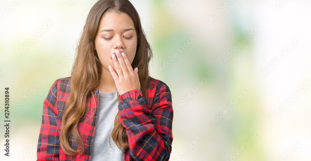 Young beautiful brunette woman wearing a jacket over isolated background bored yawning tired covering mouth with hand. Restless and sleepiness.