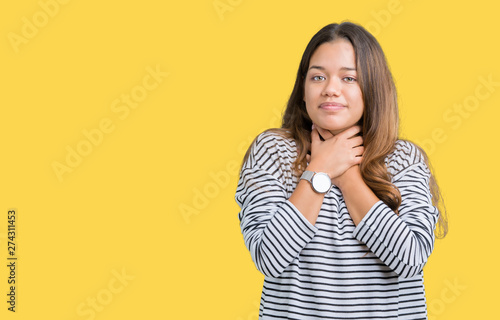 Young beautiful brunette woman wearing stripes sweater over isolated background shouting and suffocate because painful strangle. Health problem. Asphyxiate and suicide concept.