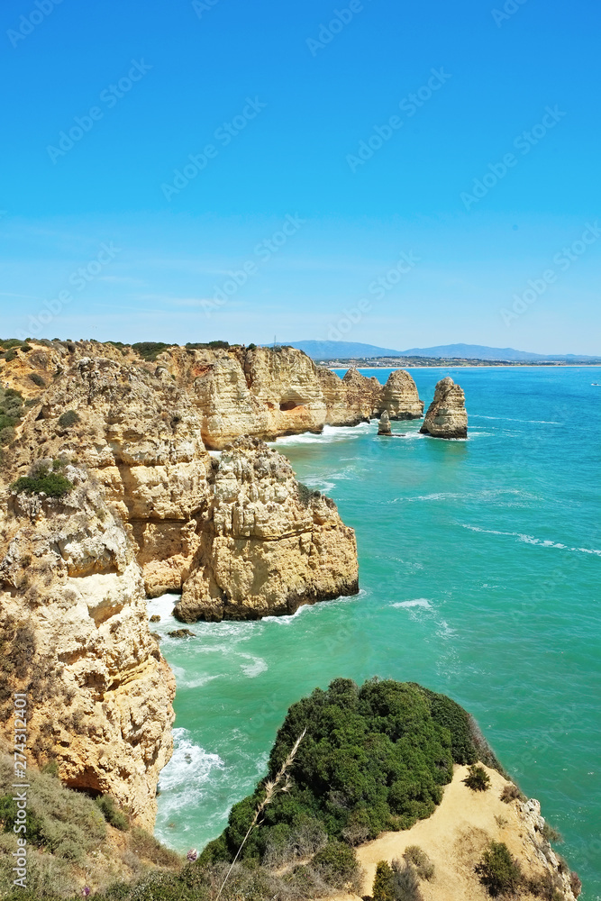 Rocky beaches with cliffs somwhere, somwhere in Algarve, Portugal. Atlantic ocean shore background. Copy space for text. Rocky beaches with cliffs somwhere, somwhere in Algarve, Portugal. Atlantic ocean shore background. Copy space for text.