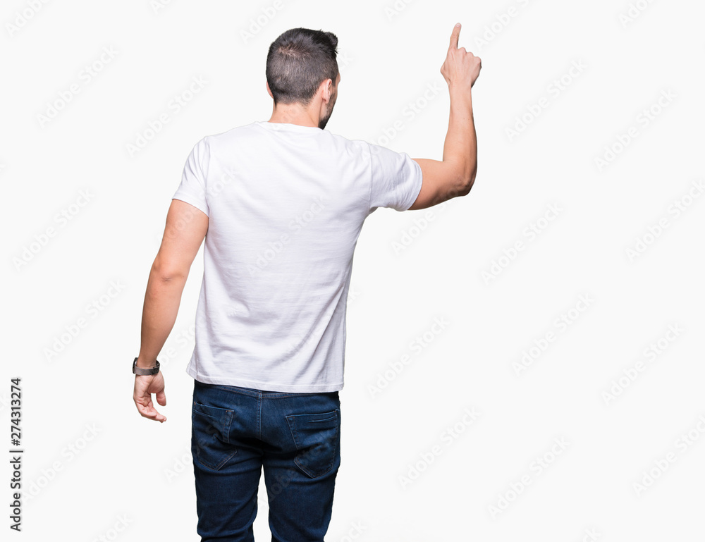 Handsome man wearing white t-shirt over white isolated background Posing backwards pointing behind with finger hand
