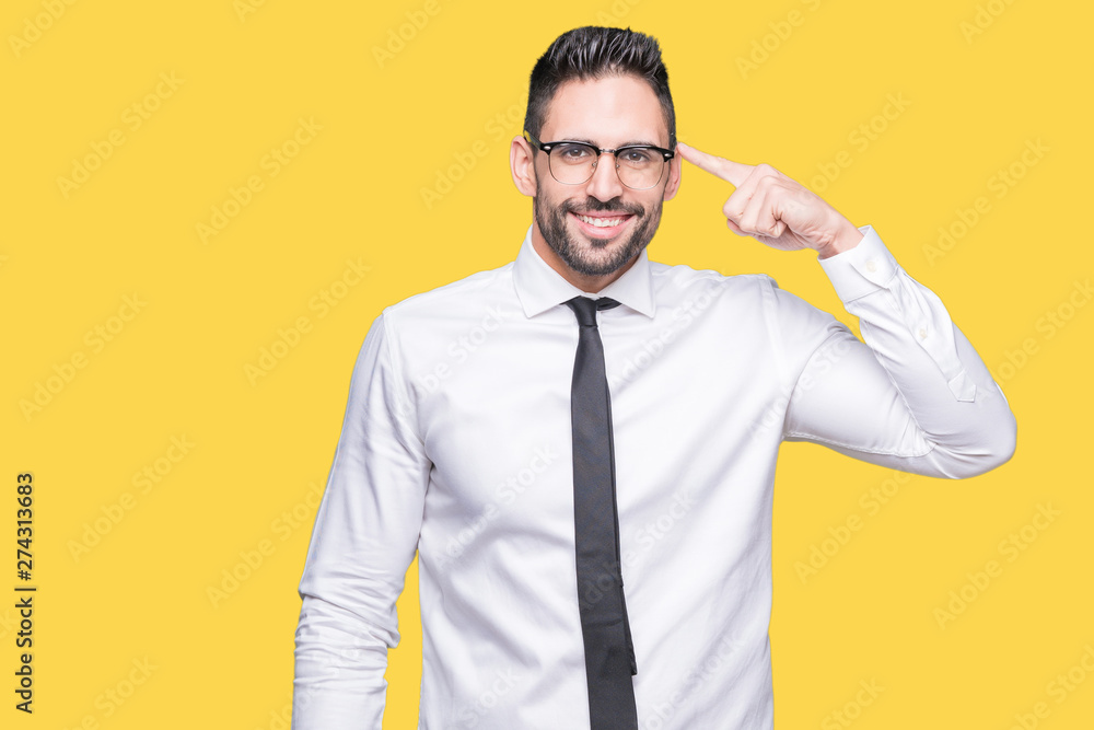 Young handsome business man wearing glasses over isolated background Smiling pointing to head with one finger, great idea or thought, good memory Young handsome business man wearing glasses over isolated background Smiling pointing to head with one finger, great idea or thought, good memory