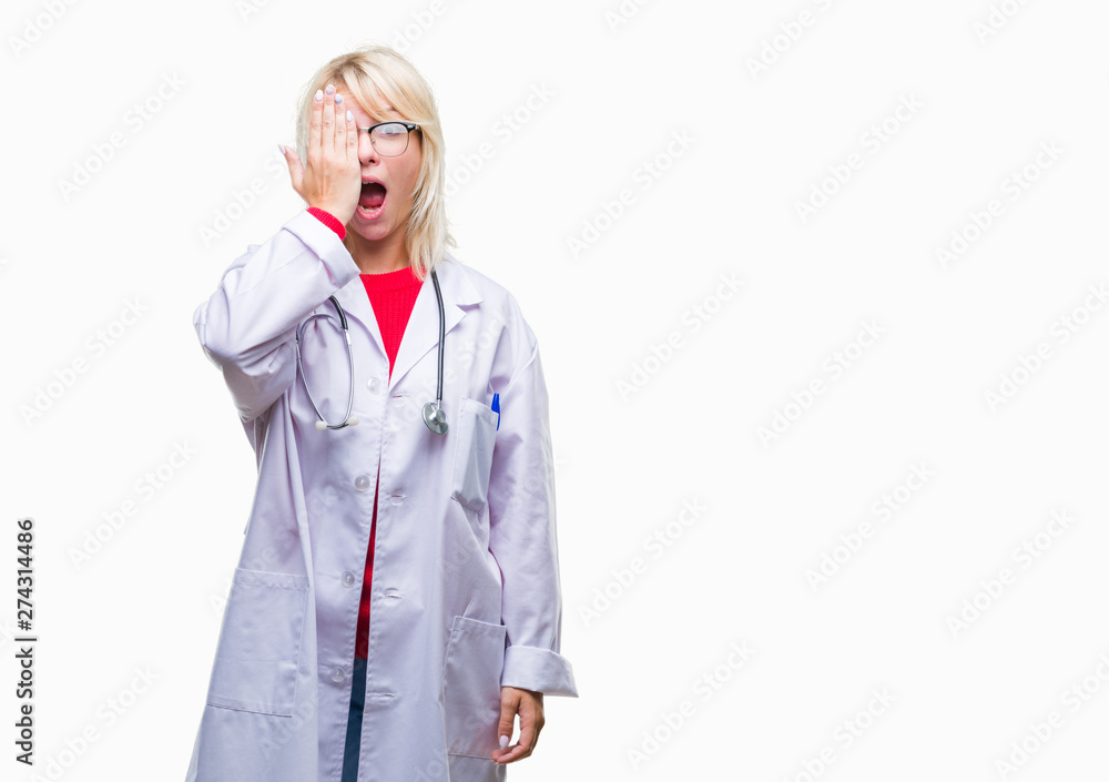 Young beautiful blonde doctor woman wearing medical uniform over isolated background covering one eye with hand with confident smile on face and surprise emotion. Young beautiful blonde doctor woman wearing medical uniform over isolated background covering one eye with hand with confident smile on face and surprise emotion.