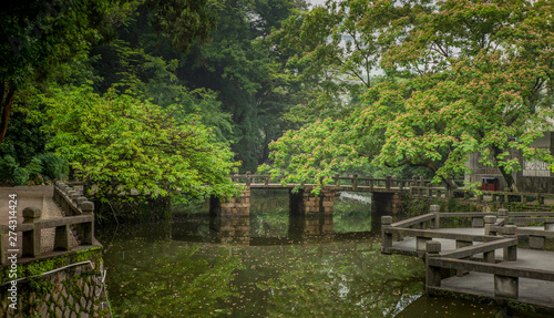 Traditional Chinese bridge on a small water canal in a park in Wenzhou in China