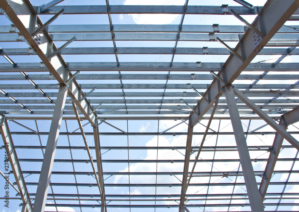The structure of the steel frame for building construction on sky background. Zinc metal coating to protect against corrosion. The structure of the steel frame for building construction on sky background. Zinc metal coating to protect against corrosion.