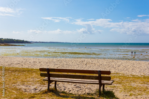 Bench with a view of a beautiful beach in Kerleven, Brittany, France, on a sunny day