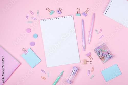 School background with notebooks and pastel colorful study accessories on pink background Back to school concept with copy space for text