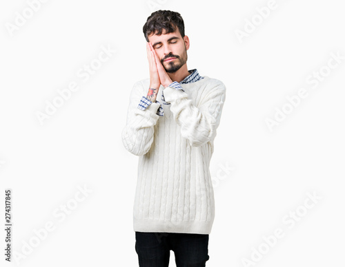 Young handsome man wearing winter sweater over isolated background sleeping tired dreaming and posing with hands together while smiling with closed eyes.
