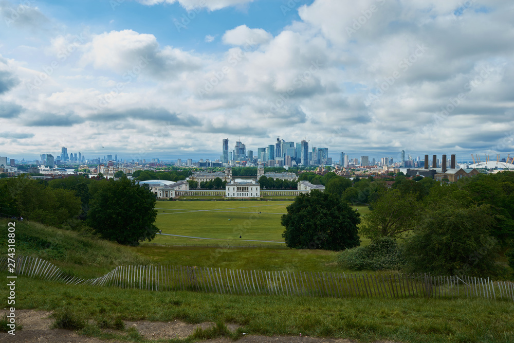 LONDON, ENGLAND/UNITES KINGDOM –– JUNE 11 2019: View of London from Greenwich park at cloudy summer day