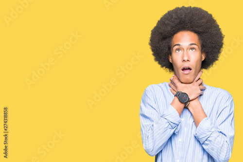 Young african american man with afro hair shouting and suffocate because painful strangle. Health problem. Asphyxiate and suicide concept. © Krakenimages.com