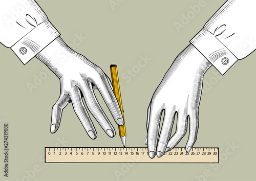 Female hands with pencil and ruler