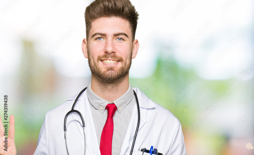 Young handsome doctor man wearing medical coat showing and pointing up with fingers number three while smiling confident and happy. Young handsome doctor man wearing medical coat showing and pointing up with fingers number three while smiling confident and happy.