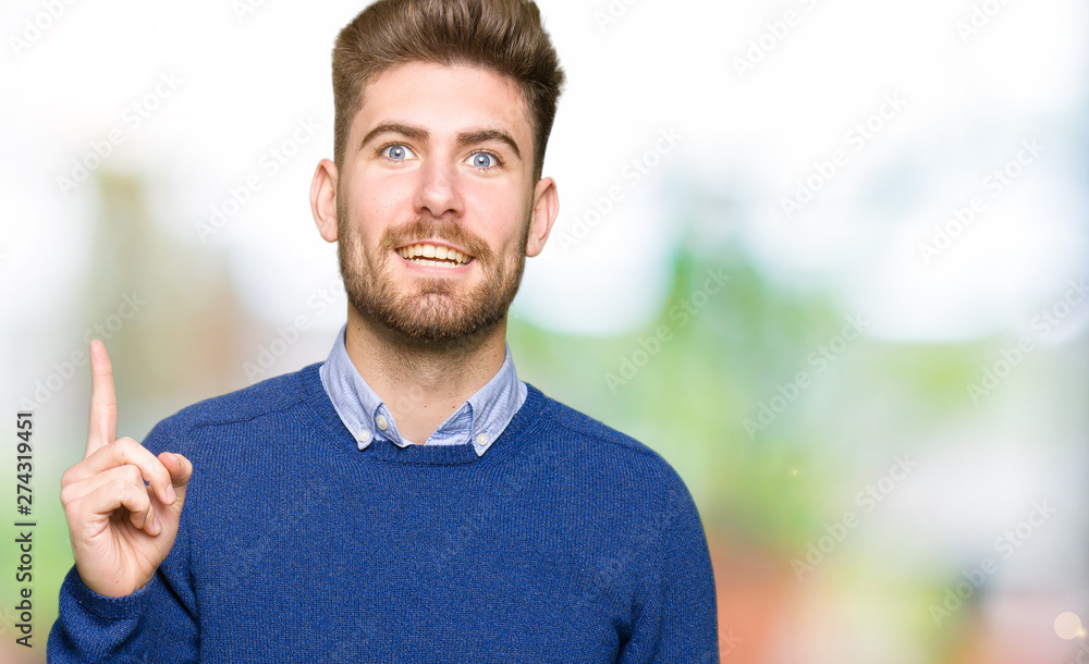 Young handsome bussines man pointing finger up with successful idea. Exited and happy. Number one. Young handsome bussines man pointing finger up with successful idea. Exited and happy. Number one.
