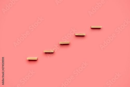 Fotografie Five wooden pegs form a staircase