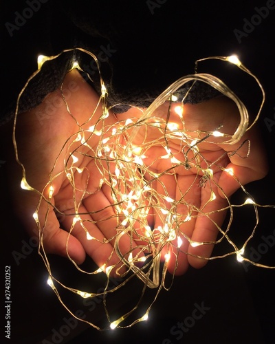 Woman hands holding string of light