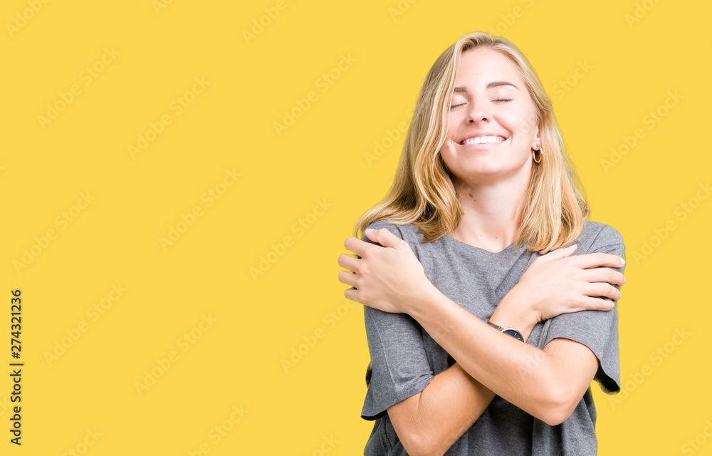 Beautiful young woman wearing oversize casual t-shirt over isolated background Hugging oneself happy and positive, smiling confident. Self love and self care - obrazy, fototapety, plakaty 