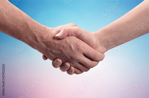 Business handshake and business buildings on light background