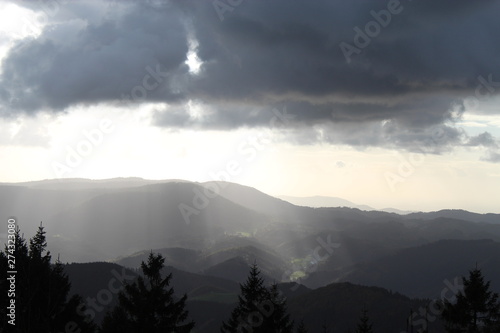 sunbeams trough thunderclouds in black forest valley